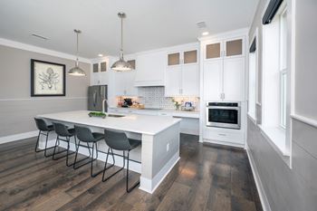 a kitchen with white cabinets and a white counter top
